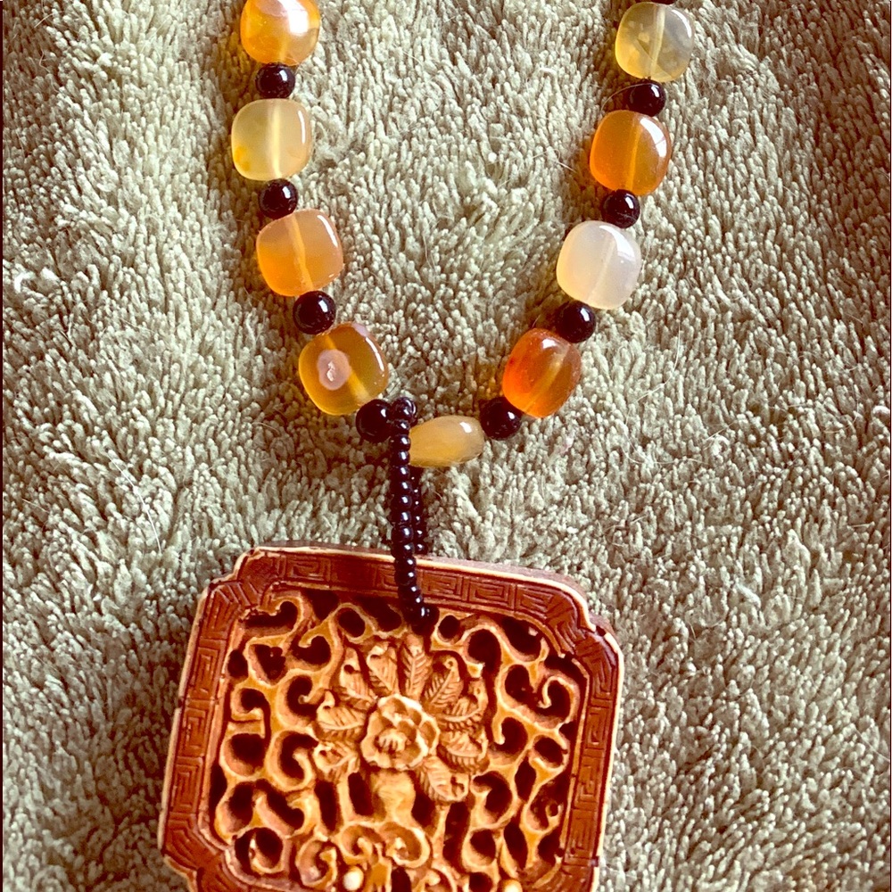 Brown/amber colored beaded necklace/medallion.